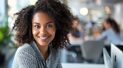 Obraz premium an image of a confident young professional African American woman with curly hair and a warm smile