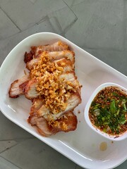 Close up roasted pork, grilled pork with Spicy Dipping Sauce Thai food.