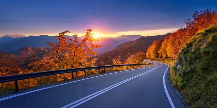 Beautiful, scenic road through the mountains at sunset in autumn, with the suns etting behind the mountains on horizon