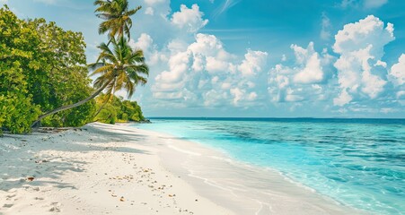 Beautiful tropical beach with white sand, palm trees, turquoise ocean against blue sky with clouds on sunny summer day, Maldives.