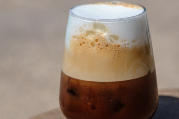 Closeup view of an iced greek  coffee, also known as freddo cappuccino with a straw in Ios Greece