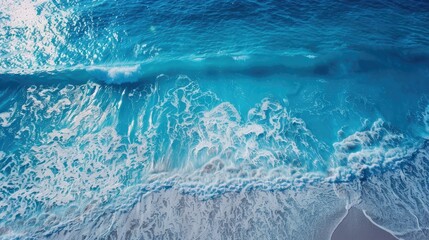 Aerial view of a vibrant blue ocean with picturesque waves, creating a mesmerizing pattern along the shoreline