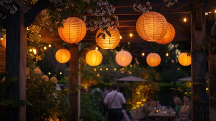 Lanterns hanging from a pergola, casting a soft, orange glow over an outdoor gathering space