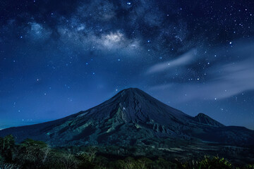 Generative ai on theme of mountain range with visible silhouettes through the morning colorful fog
