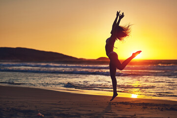 Woman, sunset and jump silhouette on beach, horizon and holistic wellness for energy in nature....