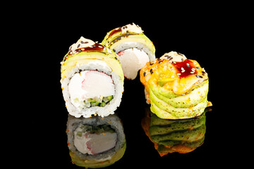 Sushi Hot Roll, Sushi menu. Japanese food.Set with fried and baked rolls, sushi on a black board on a light table. Avocado. 