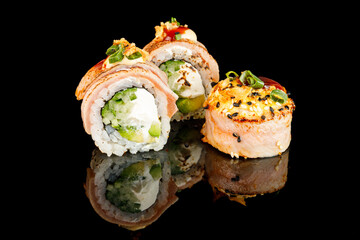 Sushi Hot Roll, Sushi menu. Japanese food.Set with fried and baked rolls, sushi on a black board on a light table.