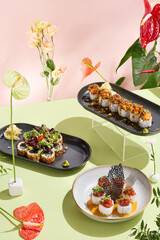 Gourmet sushi set on elegant dark plates with vibrant anthuriums and soft shadows
