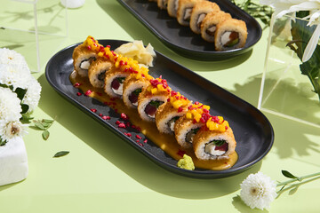 Tempura sushi roll with tuna and mango sauce on a minimalist table, with surreal spring decor