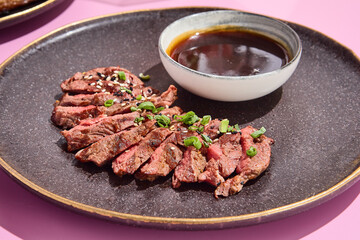 Succulent beef alternative steak presented with a rich dipping sauce, styled for a modern culinary experience