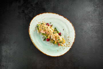 Fresh and vibrant salad featuring avocado, crab, and quinoa, beautifully served on a turquoise plate with speckled detail