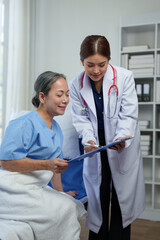 A friendly doctor talks with a retired female patient resting in bed. Full recovery after illness Doctor gives advice on health care Physical examination, treatment advice, medicine, health insurance