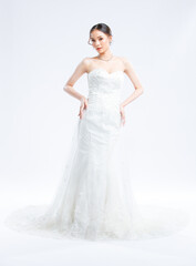 Fototapeta premium Asian young beautiful female portrait attractive model gorgeous charming bride wearing fashion wedding dress luxury perfect style, posing standing smile looking camera isolated white background studio