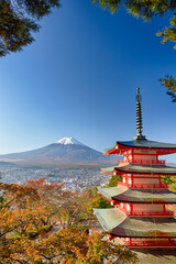 Fototapeta premium Famous Japan Destinations. Renowned Kiyomizu-dera Temple Pagoda Against Kyoto Skyline with Traditional Red Maple Trees Against Fuji Mountain