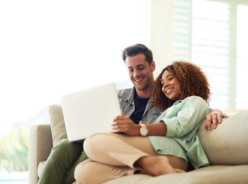 Smile, internet and interracial couple with laptop for watching online video and streaming movie in living room. Happy, black woman and man with computer for social media app and subscription service