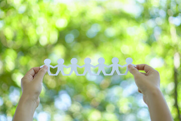 Team of business professionals holding  green sustainability icon, symbolizing their commitment to nature and sustainable practices. showcasing unity and environmental responsibility.