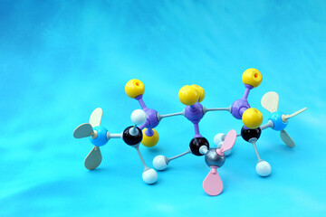 Simulate Shape of covalent molecules on a blue background. Soft and selective focus.