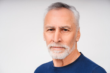 Portrait of mature cheerful man posing isolated over white background in studio