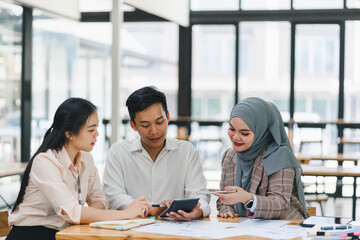 Diverse team collaborating in modern office during daytime meeting