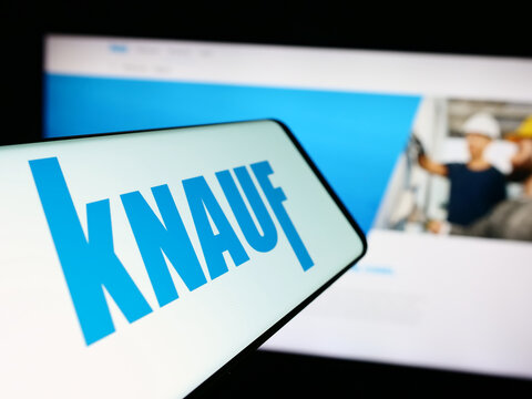 Stuttgart, Germany - 05-23-2024: Smartphone with logo of German building materials company Knauf Gips KG in front of business website. Focus on center-left of phone display.