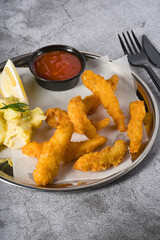 Deep fried shrimp tempura with potato salad on a metal plate