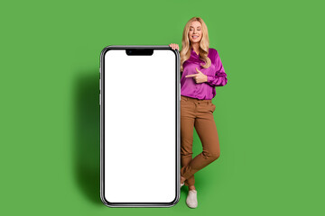 Full length photo of cute dreamy woman wear violet shirt showing apple iphone samsung gadget empty...