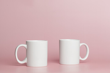 white cups for tea or coffee on a pink background