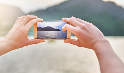 Outdoor, hands and screen of smartphone for adventure, vacation and holiday journey in New Zealand. Beach, person and cellphone for photography, picture and camera memory of mountain from traveling