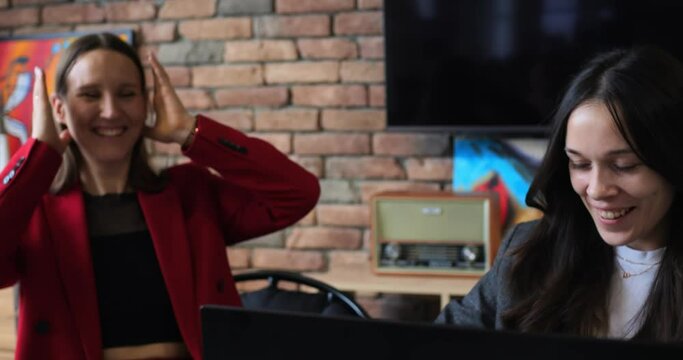 Women work happily together. Visual merchandising team, planning and strategizing product displays. Collaborating on effective design layouts to enhance customer experience and boost sales.