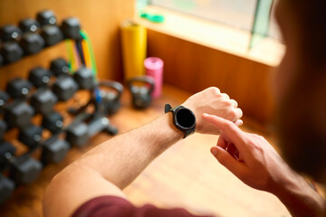 Close Up Shot Of Man Exercising In Gym Checking Health Monitoring App On Smart Watch
