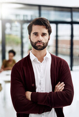 Obraz premium Arms crossed, confident and portrait with designer man in boardroom of office for project management. Business, creative and leadership with serious employee in workplace for career development