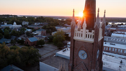 Natchez, Mississippi, USA - April 21, 2024: Sunset light shines on a historic church and landscape...