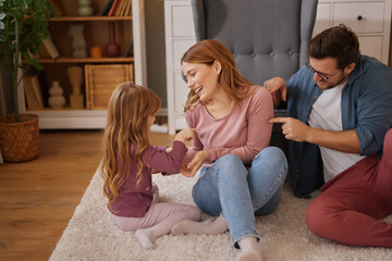 Parents having fun with their little daughter at home