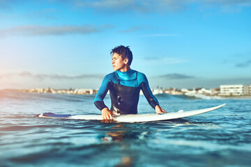 Teenager, boy and surfing with waves, summer and happiness with fitness, water and seaside. Surfer,...