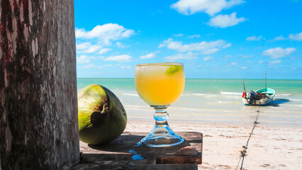 Fruit cocktail on a white sand beach in summer. High quality photo