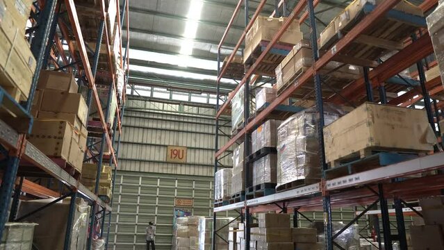 workers in the warehouse. pile of packages in the warehouse. packages arranged on warehouse shelves