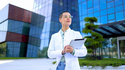 Happy, young female doctor enjoying outdoors
