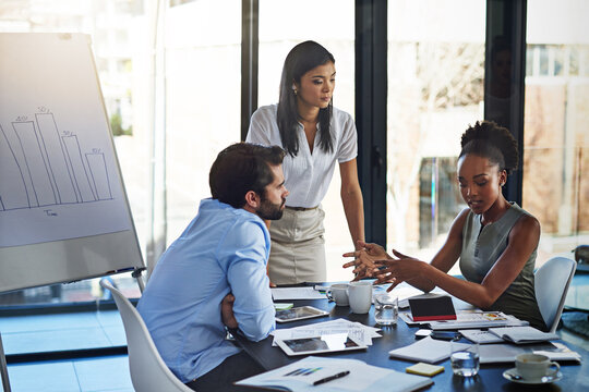 Business people, strategy meeting and audit with paperwork and charts in boardroom for budget planning. Corporate group, teamwork and company review with communication for discussion about spending