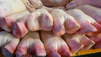 Carefully peeled pork legs ( bone-in pigs feet, pig trotters) on the counter of an Iranian bazaar, souq
