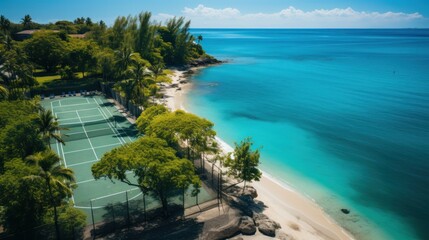 Fototapeta premium Overhead view of a lush tropical beach resort featuring a tennis court beside the clear blue sea