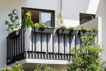 Modern Balcony with Plants. Balcony Railing of Tarpaulin Fabric Privacy Screen Balustrade. Exterior...