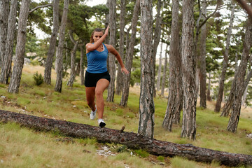 Fearless Woman Conquering Wooden Obstacles in the Dangerous Forest Terrain.