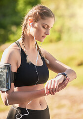 Fitness, woman and watch tracking training or health outdoors with mobile and earphones for...