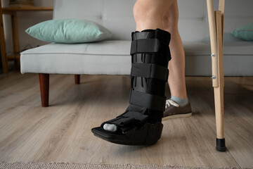woman in bandage walks with the help of crutches. Ankle injury