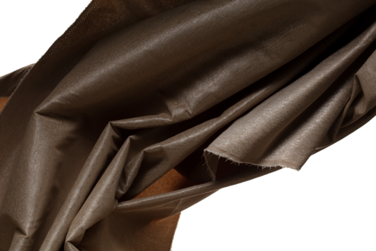 Brown gold canvas fabric flying in curve shape, Piece of textile Brown gold canvas fabric throw fall in air. White background isolated, dark shading environment