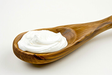 a wooden spoon with whipped cream on it