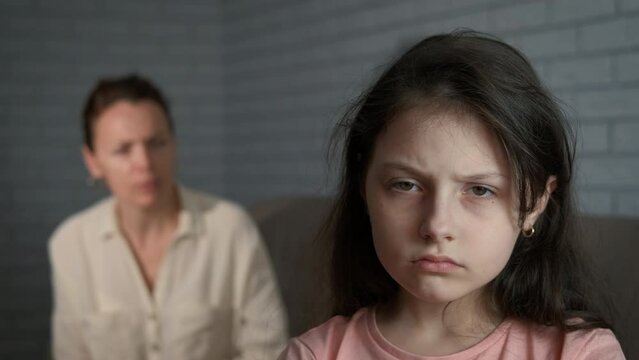 Family at different generations gap. A female screaming to her daughter on the sofa. A concept of relationships problems and generation misunderstanding in the family.