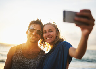 Man, woman and selfie at beach for sunset, travel and vacation to island in summer for love. Happy,...