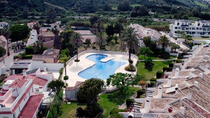 Aerial view of architecturally-designed modern prestige homes with pools in outer suburban Spain