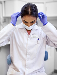 Girl, face mask and prepare in hospital for surgery or medical protocol, protective gear and safety for virus or hygiene in clinic. Woman, doctor and surgeon professional for healthcare and medicine.